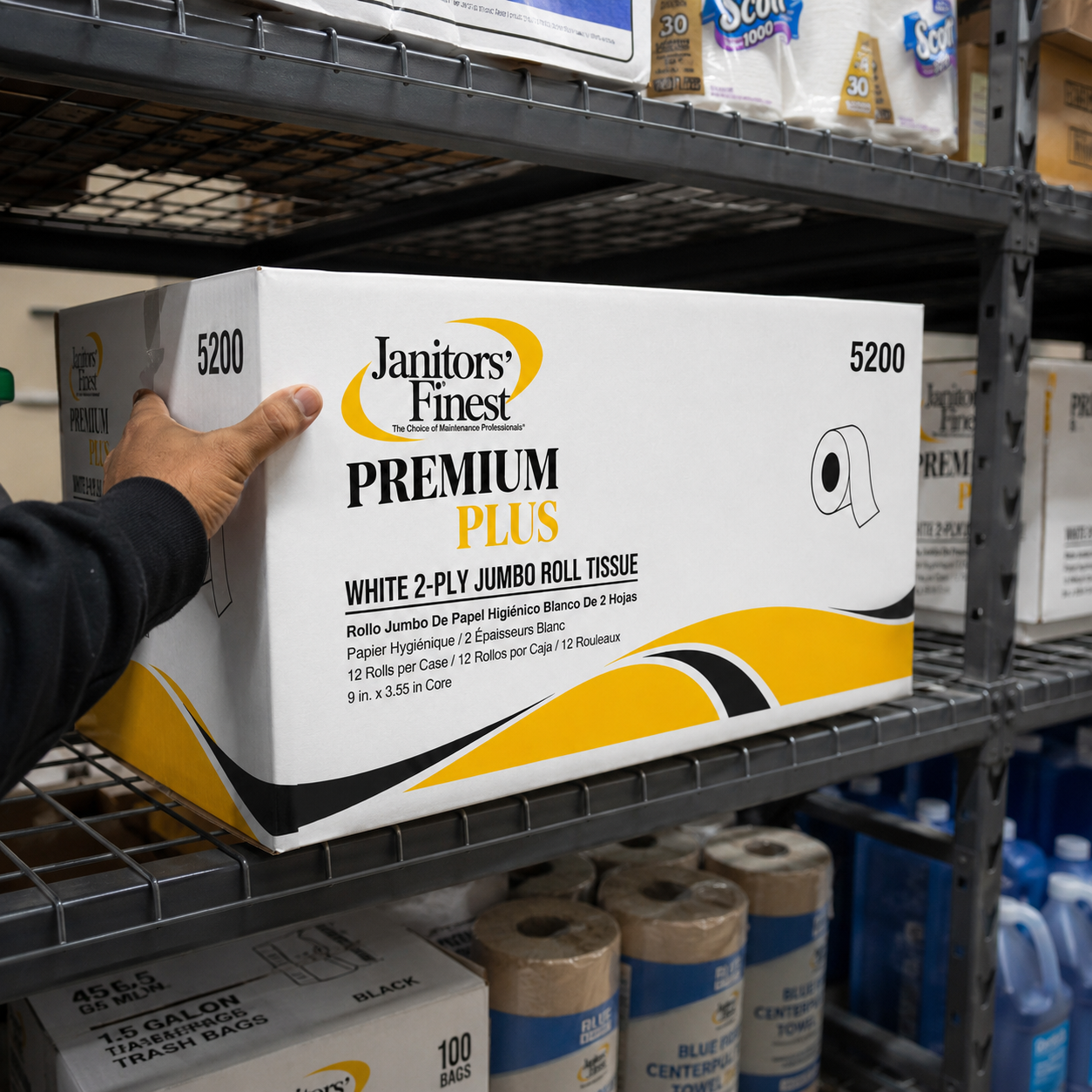 Worker pulling Janitors Finest 5200 jumbo roll tissue case from a warehouse shelf