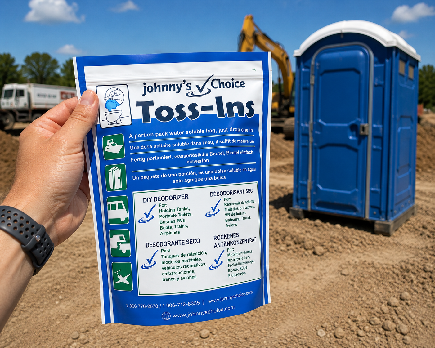Hand holding Toss-Ins pouch at a construction site with portable restrooms